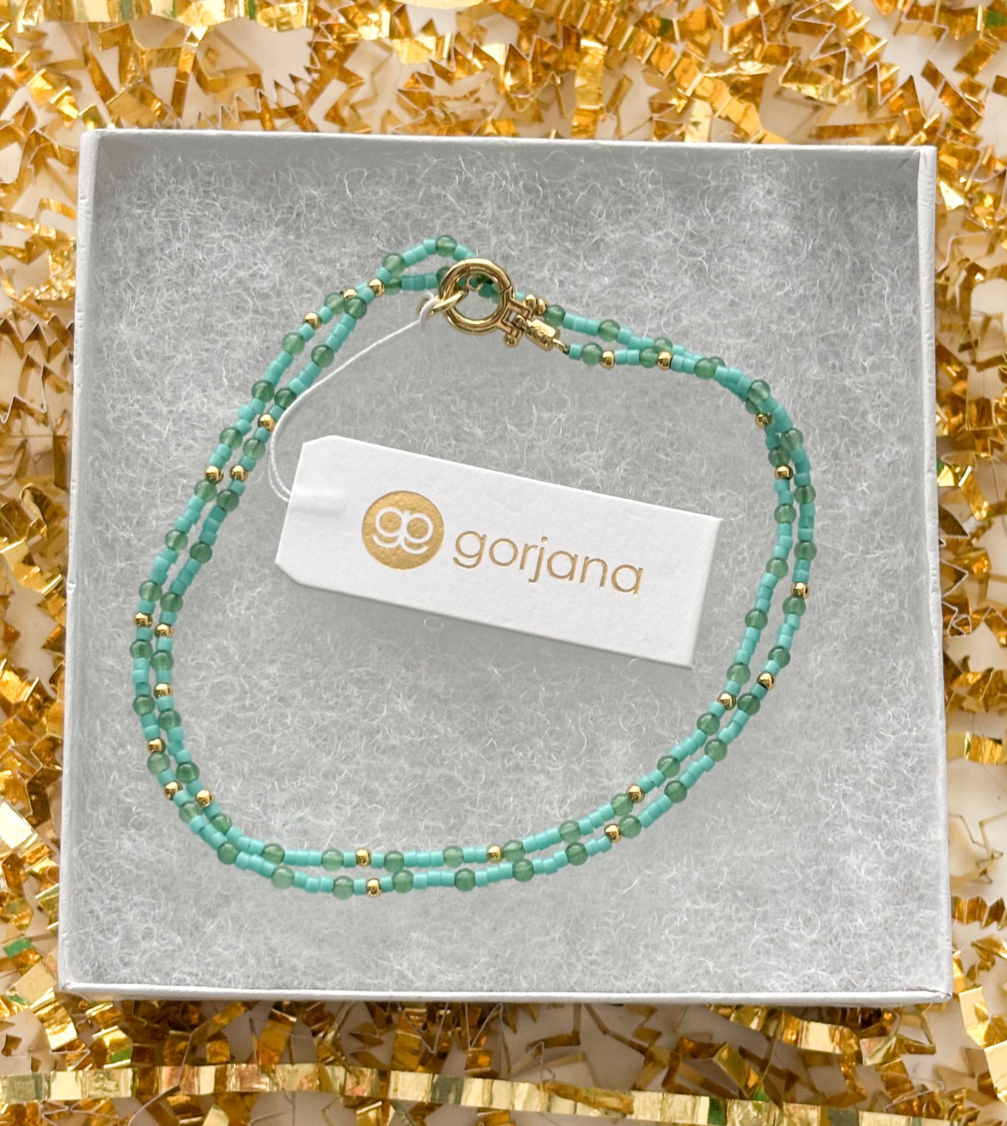 Emerald Glow Luxury Gift Set — Eco-Friendly Green Simonetta Clutch, Spongellé Edelweiss Spa Buffer & Gorjana Aventurine Necklace